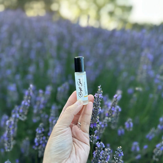 Floral, Fresh & Fruity Essential Oil Natural Perfume, displayed against a background of purple blooming lavender field at Lavender Backyard Garden, New Zealand.
