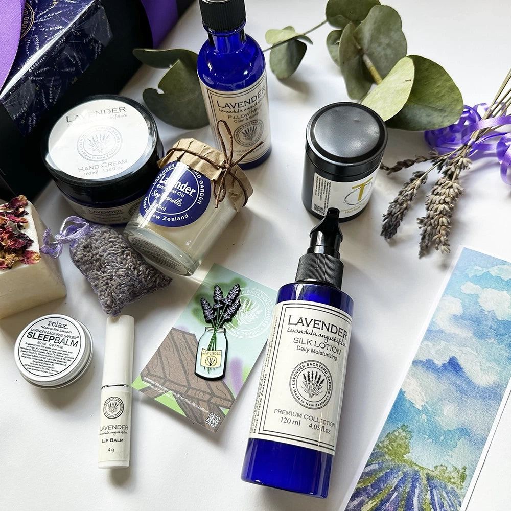 Close-up of luxury lavender gift set highlighting Lavender Lip Balm, Lavender Silk Lotion, and Lavender Field Bookmark. A beautiful self-care collection designed for relaxation, perfect as a thoughtful gift for women.