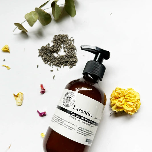 Therapy Lavender Hand Wash - Liquid soap scented by essential oils, with background decor of eucalyptus leaves, lavender dried flower buds, and a dried yellow rose, enhancing the natural, calming essence of the hand wash.