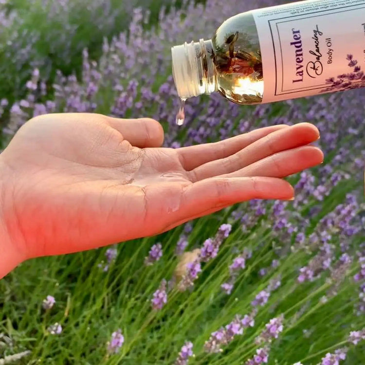 Lavender body and massage oil with argan oil, set against blooming lavender fields