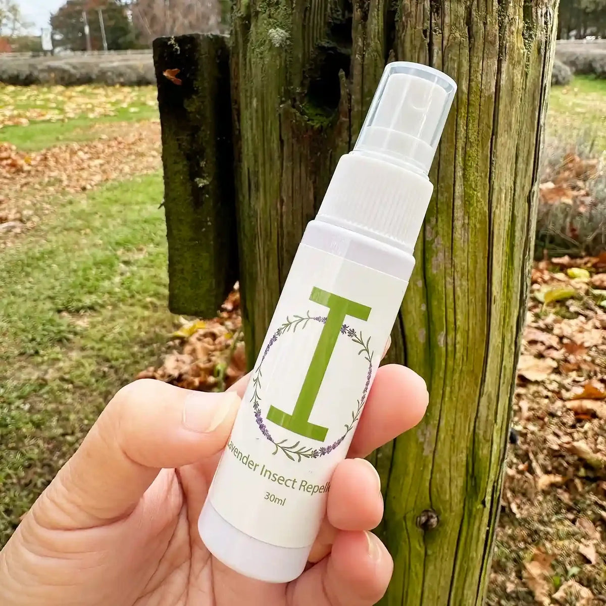 30ml travel size lavender insect repellent spray in front of a lavender farm paddock in New Zealand